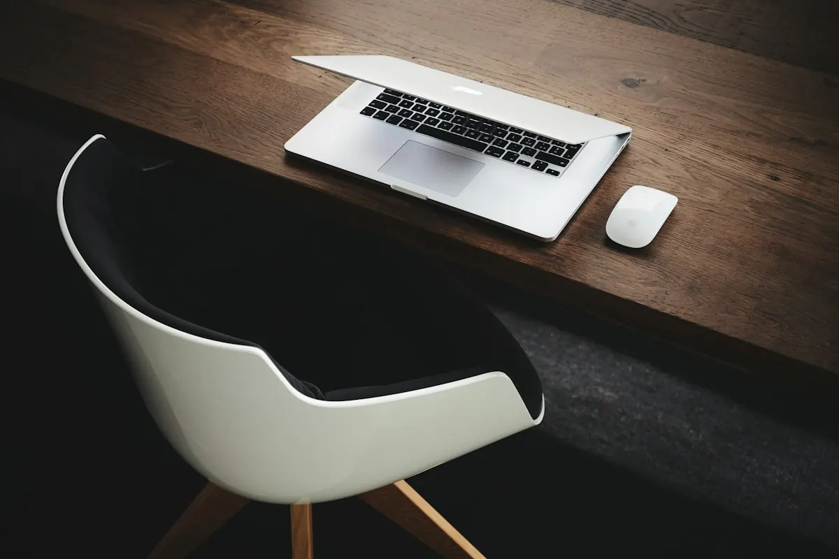 A laptop on a wooden desk, ready to create a listing